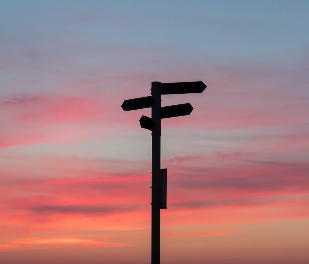 street sign against a sunset sky