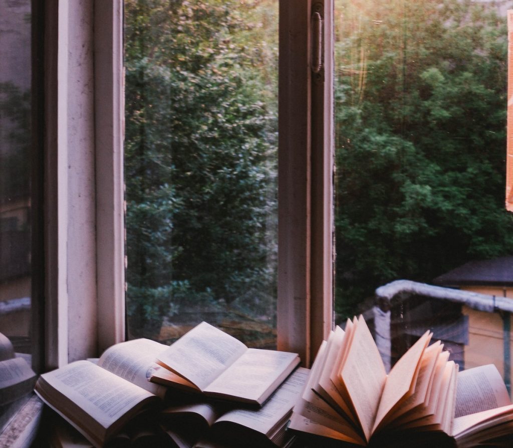 books in window sill in morning